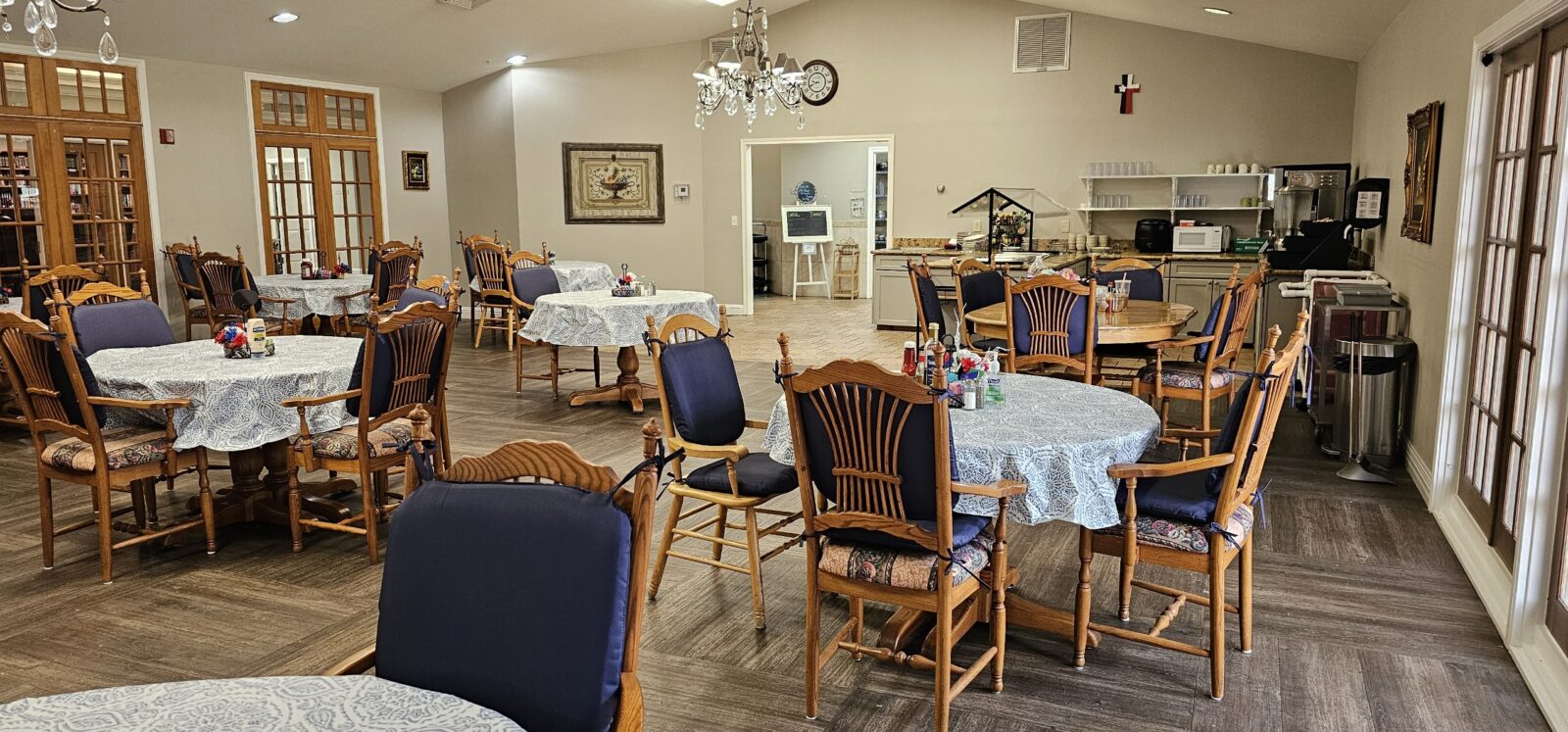 Dining area with wooden chairs and round tables.