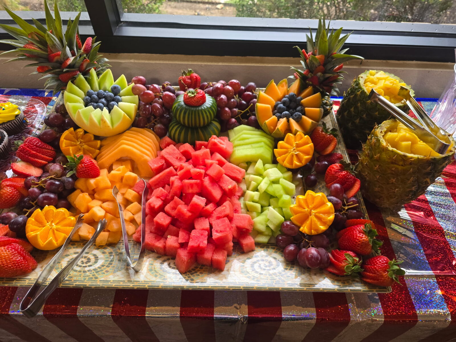 Vibrant fruit platter with diverse colorful fruits arranged beautifully.