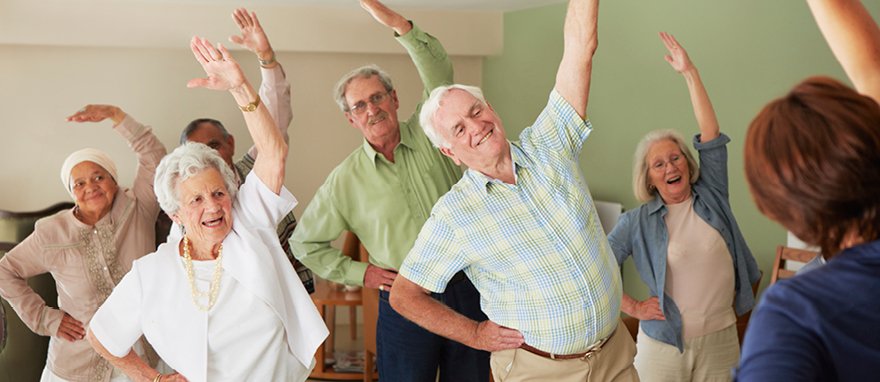 Seniors participating in a joyful exercise class together.